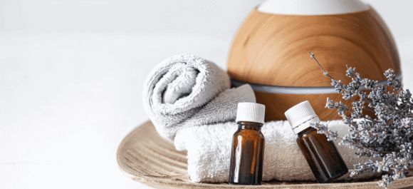 close-up-air-humidifier-natural-aromatic-oils-towels-lavender-sprigs-aromatherapy-health-care-concept-background